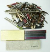 A collection of pens, propelling pencils, parts and accessories including yellow metal and