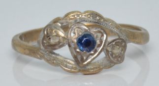 A 9ct gold ring set with a sapphire and two diamonds in a heart setting, 1.9g, size M
