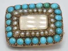Victorian brooch set with a glass compartment surrounded by seed pearls and a further border of