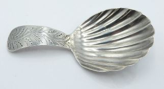 George III hallmarked silver caddy spoon of shell shaped form, the handle with bright cut