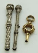 Hallmarked silver wrythen pencil, similar pencil and a yellow metal or similar pocket watch key