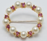 A 9ct gold brooch set with pearls and rubies, diameter 2cm, 3.2g