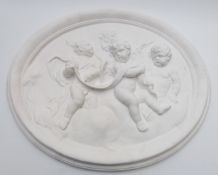 Large oval plaster plaque depicting cherubs, width 59cm