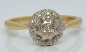 An 18ct gold ring set with diamonds in a cluster, 3.7g, size M
