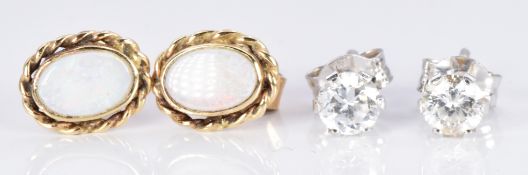 A pair of 18ct white gold earrings and a pair of 9ct gold earrings set with opals