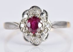 An 18ct gold ring set with a ruby and diamonds in a platinum setting, 1.9g, size K