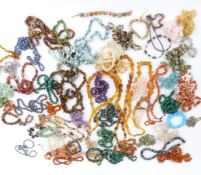 A collection of hardstone necklaces including rose quartz, tiger's eye, pressed amber, malachite etc