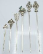 Pair of French white metal meat skewers, the ornate finials modelled as sea creatures, both with