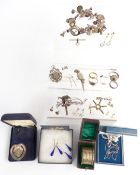 A collection of silver jewellery including charm bracelet, fob, brooches, cross, silver chain,