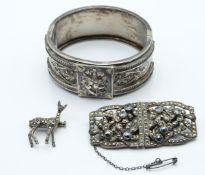 Victorian silver bangle with applied floral decoration, a French white metal metamorphic brooch
