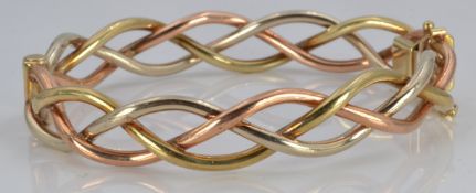 A 9ct gold tri-coloured bangle, 20.2g