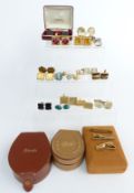 A collection of vintage cufflinks including two silver pairs