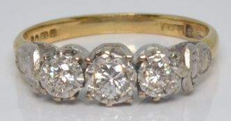An 18ct gold ring set with three diamonds in a platinum setting, 2.8g, size K
