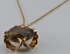 A 9ct gold pendant set with smoky quartz (London 1977) on 9ct gold chain, 12.5g