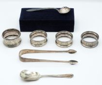 Four hallmarked silver napkin rings, Georgian hallmarked silver bright cut sugar tongs, hallmarked