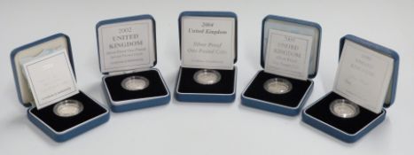 Five Royal Mint silver proof £1 coins, 1999, 2000, 2001, 2002 (with frosted finish) and 2004, all