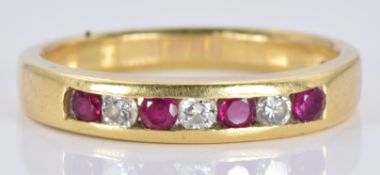 An 18ct gold ring set with alternating rubies and diamonds, 3.8g, size N