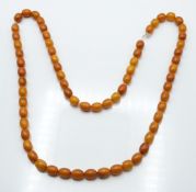 Baltic amber necklace made up of 66 oval beads, 46g