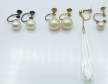 A pair of 9ct gold earrings set with pearls, a similar silver pair and two other 9ct gold earrings