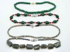 An emerald and jade necklace, two labradorite necklace, and a quartz necklace