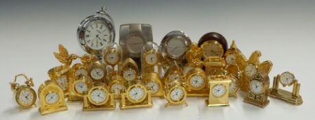 A collection of miniature brass and other clocks to include carriage style, mitre topped,