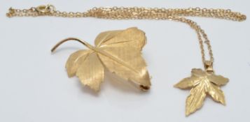 A 9ct gold leaf brooch 2.5 x 3cm, and a similar pendant on 9ct gold chain, 5.2g