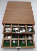 An amateur collection of 19thC and 20thC world coinage contained in a custom-made wooden three-