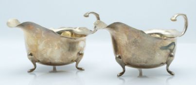 Pair of George VI hallmarked silver sauce boats raised on three feet, Birmingham 1939/40 maker
