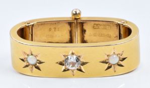 A 15ct gold scarf clip set with a cubic zirconia and opals, Birmingham 1902, 5.9g