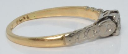 An 18ct gold ring set with a diamond in a platinum setting, 1.7g, size J/K