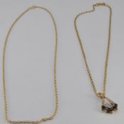 A 9ct gold pendant set with sapphires and diamonds with two 9ct gold chains, 4g