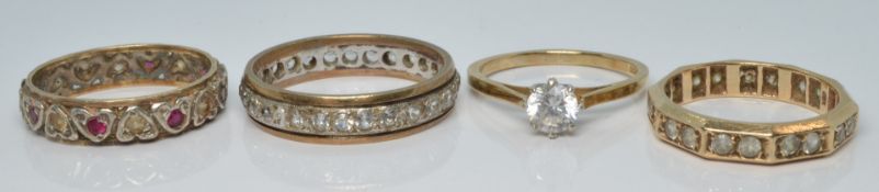 Three 9ct gold rings and a 9ct gold and silver ring, all set with paste