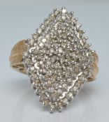 A 10k gold ring set with diamonds in a large tiered setting, 7.2g, size N