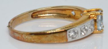 A 9ct gold ring set with an aquamarine and white sapphires, 2.5g, size N
