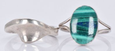 A silver ring set with malachite and another silver ring