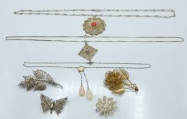 Four silver filigree brooches, two silver filigree pendants and an opalescent necklace