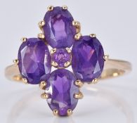 A 9ct gold ring set with five amethysts in a cluster, 3.3g, size O