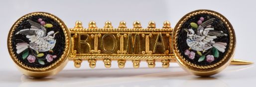 A 19thC yellow metal Italian brooch set with two micro mosaic plaques depicting doves and reading