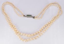 A double strand of cultured pearls, the 18ct gold and platinum clasp set with five square cut