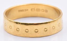 A 22ct gold wedding band/ ring with circular decoration,4.6g, size S