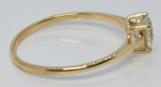 A 10k gold ring set with a heart cut csarite, with certificate, size U