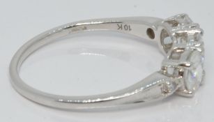 A 10k white gold ring set with three zircons and diamonds, with certificate, size S