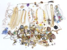 A collection of costume jewellery including vintage brooches, beads, jet brooch, foiled paste