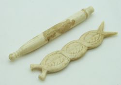 Two 19thC carved ivory needle cases comprising a Meiji period Japanese example with lion
