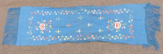 A 19th/20thC Chinese blue scarf with embroidered floral decoration and fringes, 180 x 45cm including