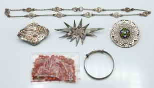 Victorian silver brooch with applied gold decoration, a silver brooch set with glass by Caithness,