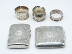 Two hallmarked silver cigarette cases and three hallmarked silver napkin rings, various hallmarks