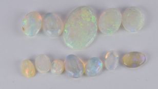 Eleven loose oval opal cabochons