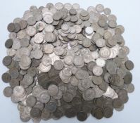 A collection of UK cupro-nickel coinage in a tin