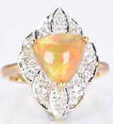A 9ct gold ring set with a Kalimaya trilliant cut opal surrounded by white sapphires, 5.1g, size M
